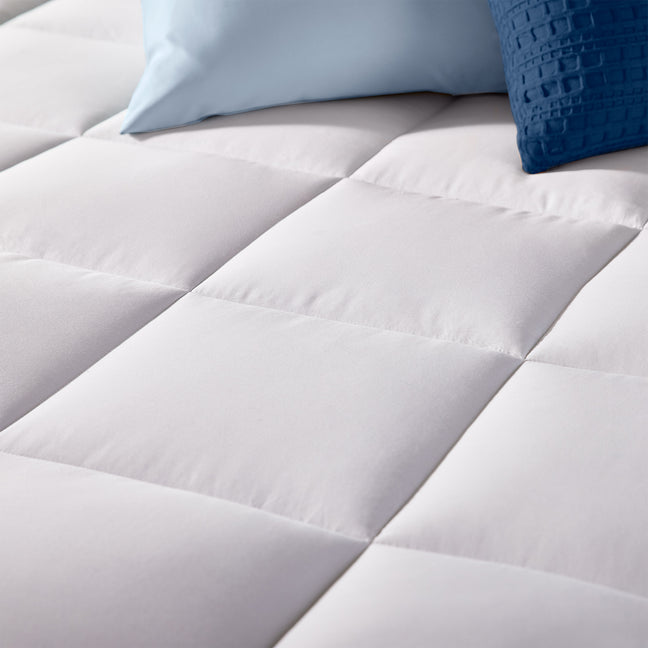 Close up view of the fiberfill mattress pad quilted cover with a boxed design